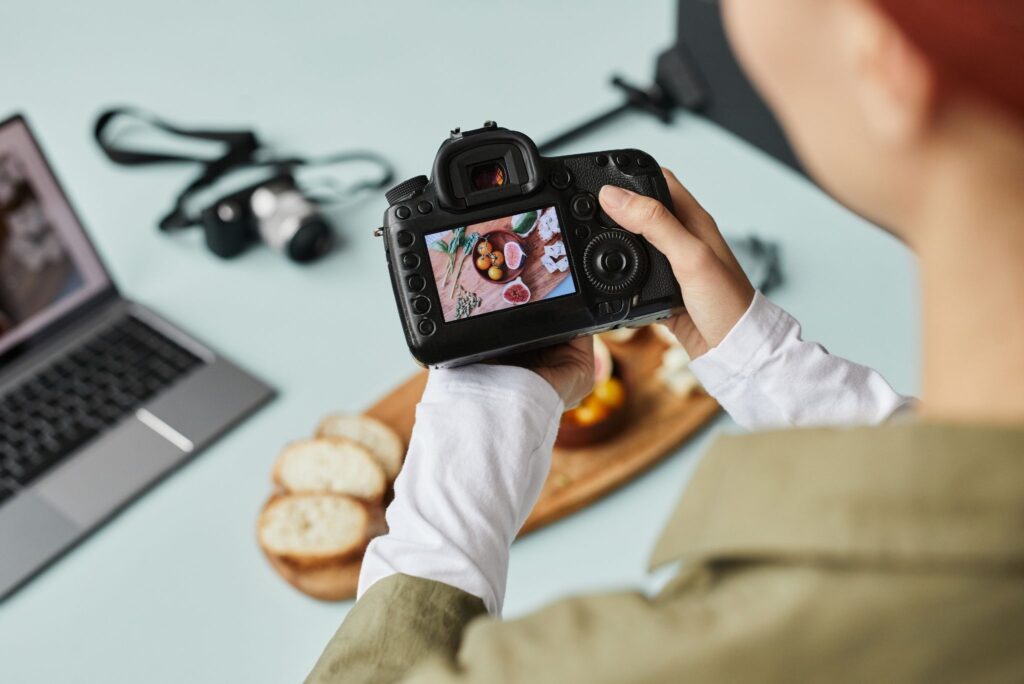 Behind-the-scenes brand photography capturing a business owner filming product content in their workspace
